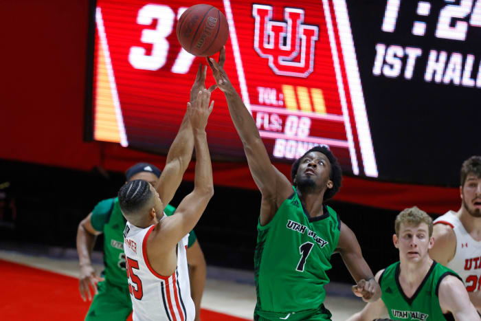 Dec 15, 2020; Salt Lake City, Utah, USA; Utah Valley Wolverines guard Le'Tre Darthard (1) blocks a shot by Utah Utes guard Alfonso Plummer (25) in the first half at the Jon M. Huntsman Center. Mandatory Credit: Jeffrey Swinger-USA TODAY Sports
